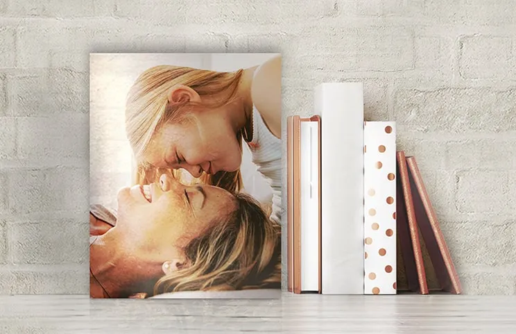 Metal photo print of mom and daughter on bookshelf