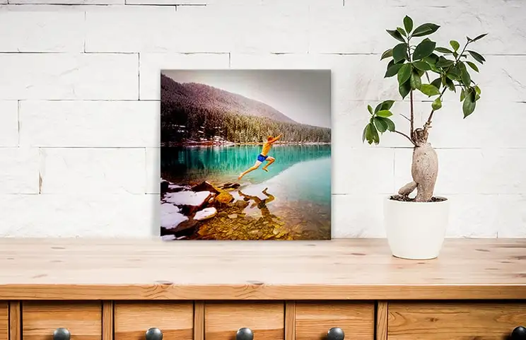 Small square metal print of man diving into lake