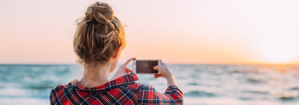 Woman taking landscape photo