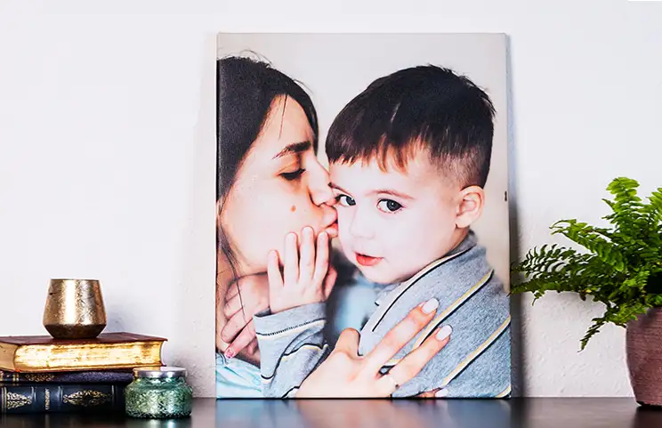 mother affectionately kissing her little son on canvas print