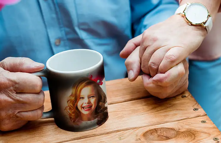 Personalised magic mug with revealed photo of young woman