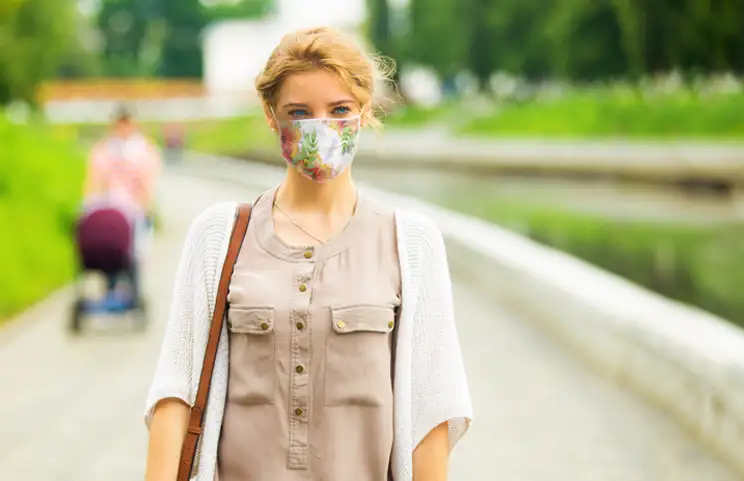 Woman wearing flower design face mask