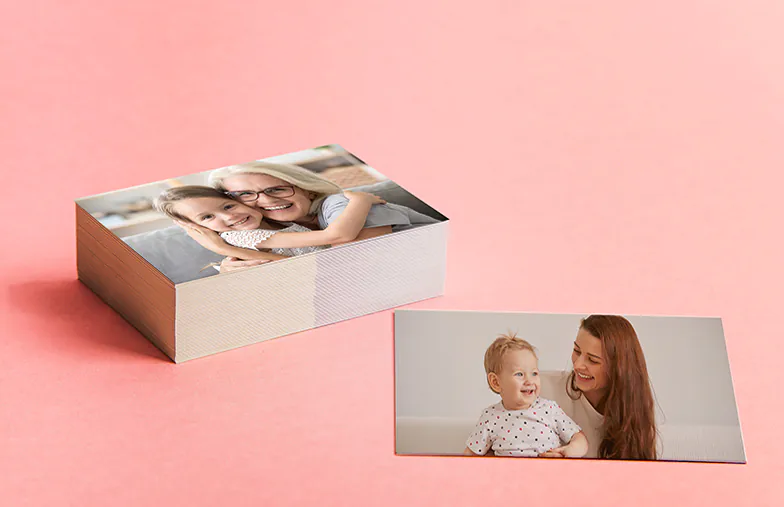 Small medium and large photo prints on table from mobile phone
