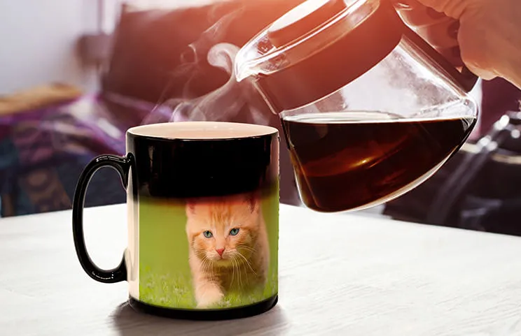 Young boy holding custom designed magic mug with photo of himself on
