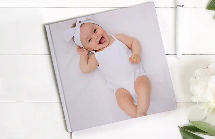 Pet and woman looking at personalised family photo book with custom design
