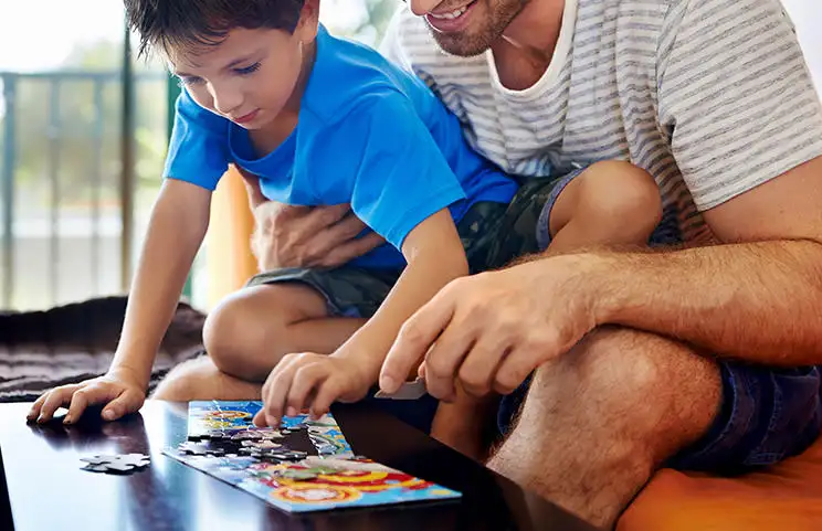 Father and son playing with puzzle