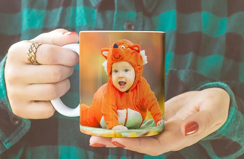 Personalized photo mug with picture of baby crawling wearing animal overall