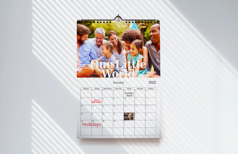 Dog photos on custom design photo calendar hung up on wall