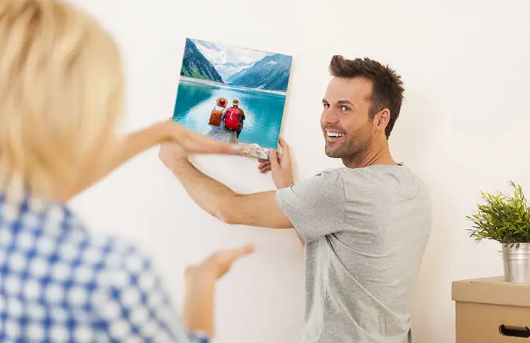 Couple putting up canvas displays